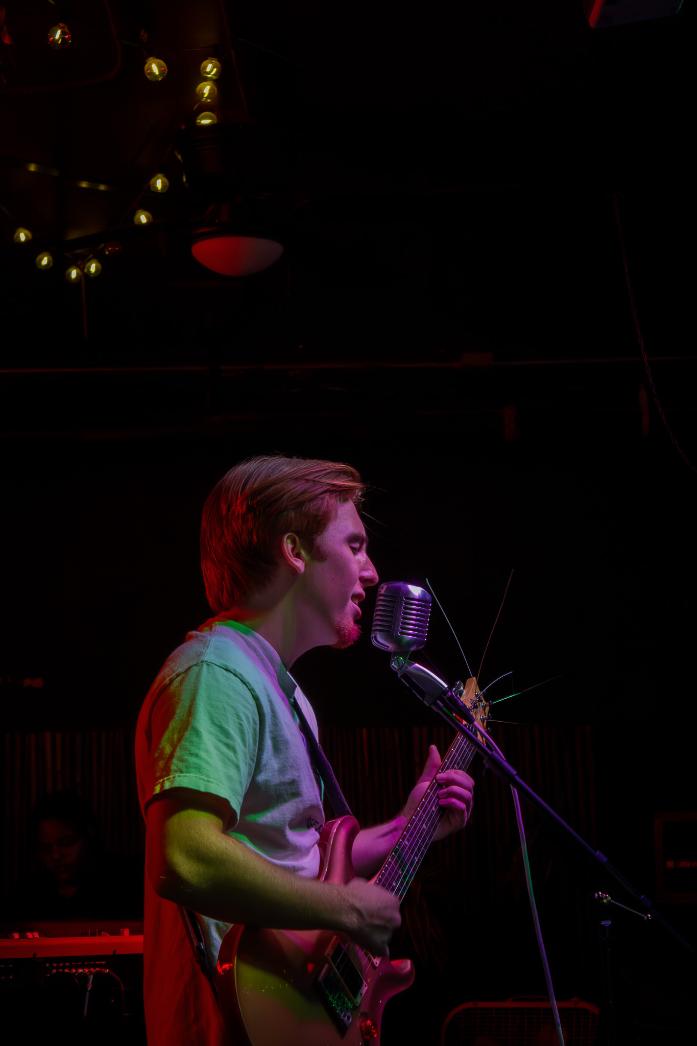 Singer guitarist at vintage microphone